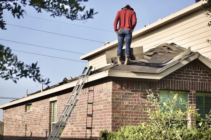 Professional roofer working on a residential roof in Cherry Village